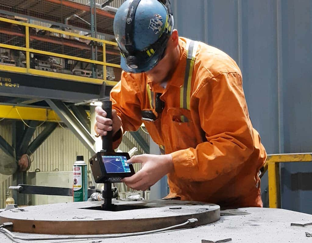 Man measuring a copper mould at steelmill